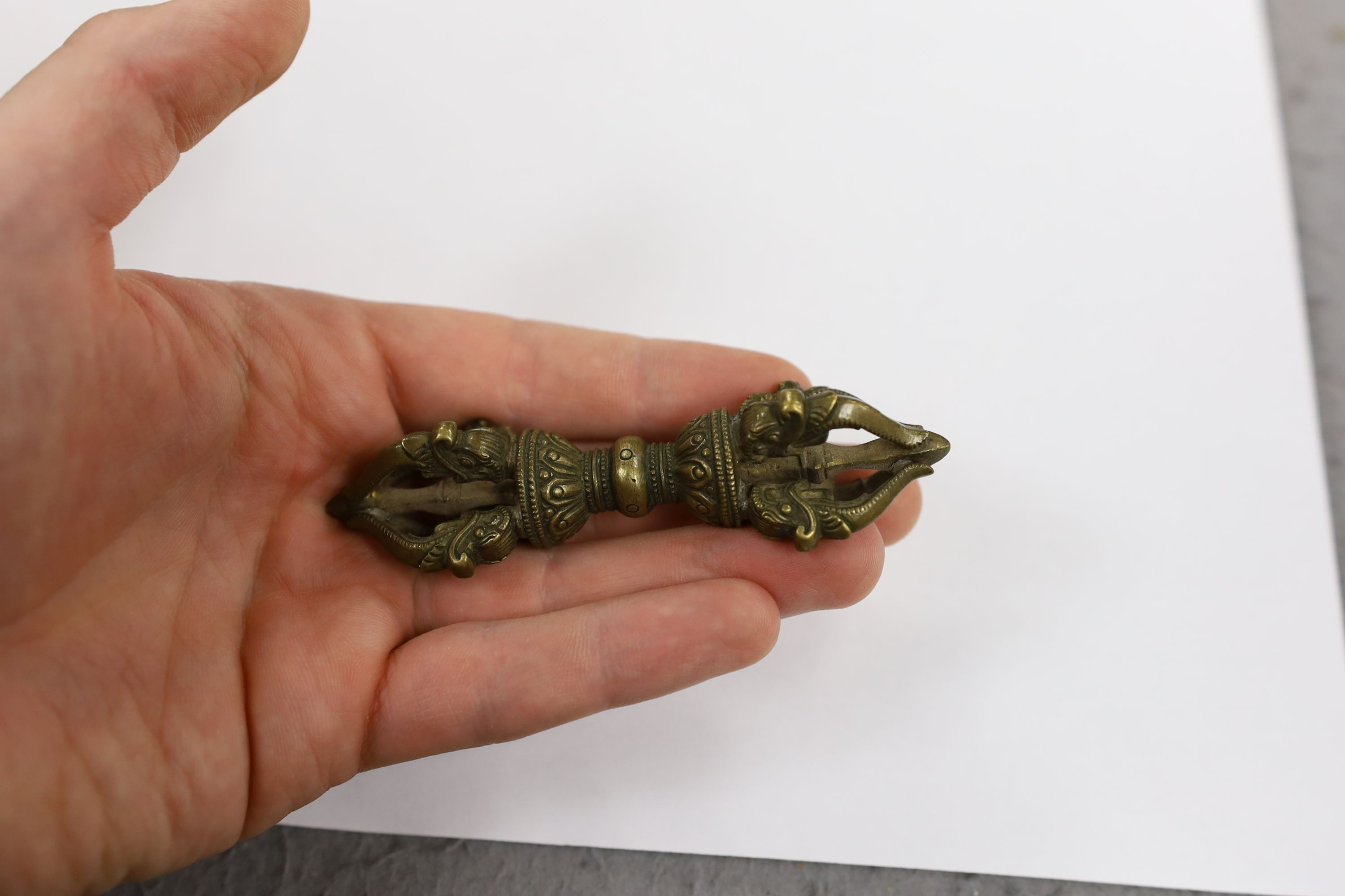 Five Chinese or Tibetan bronze figures or Buddhist implements, tallest 13cms high